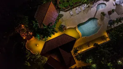 an overhead view of a swimming pool at night at Miradas Arenal Hotel & Hotsprings in Fortuna