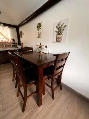 a dining room with a wooden table and chairs at Casa Los Ninos in Sámara