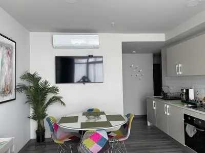 a kitchen and dining room with a table and chairs at Cozy apartment with terrace, SJ Cosmopolitan Tower #402 in San José