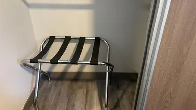 a black and white chair in the corner of a room at Cozy apartment with terrace, SJ Cosmopolitan Tower #402 in San José