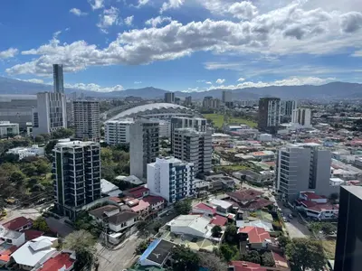 an aerial view of a city with tall buildings at Cozy apartment with terrace, SJ Cosmopolitan Tower #402 in San José
