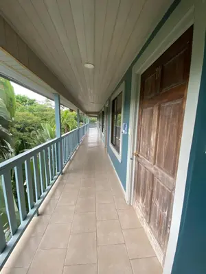 a hallway of a house with a wooden door at Hotel Ticozuma in Montezuma
