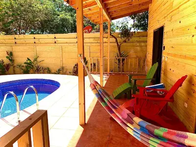 a hammock on a patio next to a pool at Ocean Melody 3 in Uvita