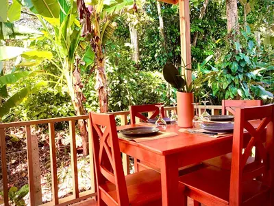 a wooden table and chairs on a porch at Ocean Melody 3 in Uvita