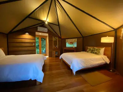 a bedroom with two beds in a tent at Hotel Arenal Glamping in Fortuna