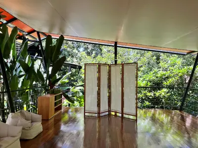 an open door on a balcony with trees at Hotel Arenal Glamping in Fortuna
