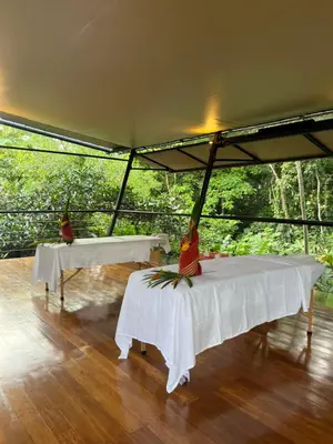 two tables in a tent with trees in the background at Hotel Arenal Glamping in Fortuna