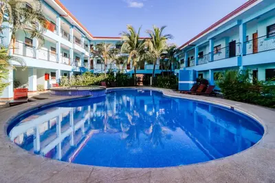 a swimming pool in front of a hotel at Marina Loft 221 in Coco