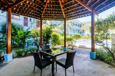a patio with a table and chairs under a pergola at Marina Loft 221 in Coco