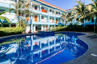 a swimming pool in front of a building at Marina Loft 221 in Coco