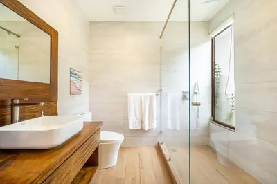 a bathroom with a white sink and a shower at Casa Coralis - Stunning modern 3 BR, 3-half bath home in Playa Potrero in Potrero