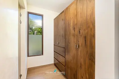 a large wooden cabinet in a room with a mirror at Casa Coralis - Stunning modern 3 BR, 3-half bath home in Playa Potrero in Potrero