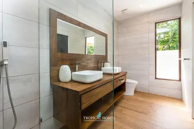 a bathroom with a sink and a mirror at Casa Coralis - Stunning modern 3 BR, 3-half bath home in Playa Potrero in Potrero