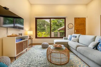 a living room with a couch and a table at Casa Coralis - Stunning modern 3 BR, 3-half bath home in Playa Potrero in Potrero