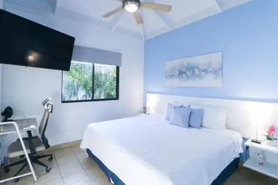 a bedroom with a bed and a desk and a window at Villaggio Claudia 29B in Potrero