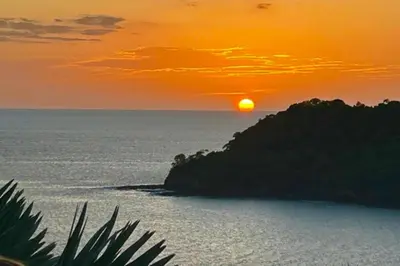 a sunset over a body of water with an island at Villaggio Claudia 29B in Potrero