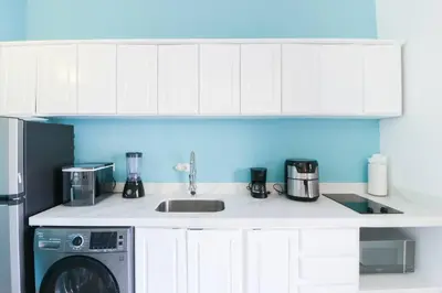 a kitchen with a sink and a washing machine at Villaggio Claudia 29B in Potrero