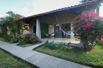 a house with a hammock outside of it at Villaggio Claudia 29B in Potrero