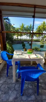 a table and chairs on a patio with a view of a pool at A 2 minutes de la PLAGE chambre du bonheur CABALLO DEL MAR in Parrita