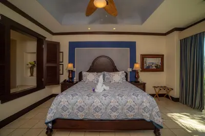 a bedroom with a bed with a stuffed animal on it at Vista Bahia 3F 1 bdr Ocean View in Los Suenos in Herradura