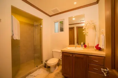 a bathroom with a toilet and a sink and a shower at Veranda 8H 3 bdr Garden View in Los Suenos in Herradura