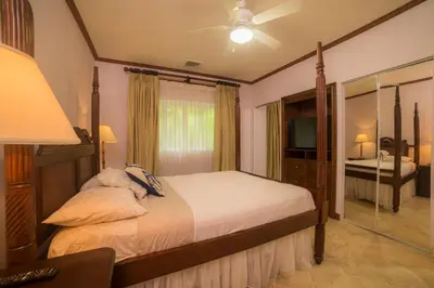 a bedroom with a bed and a dresser and a mirror at Veranda 8H 3 bdr Garden View in Los Suenos in Herradura