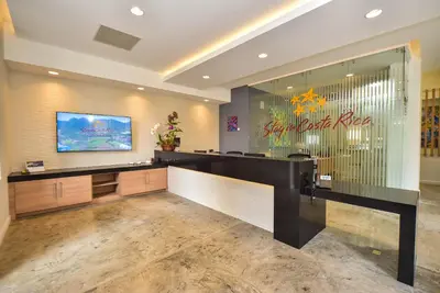 a lobby with a reception desk and a sign on the wall at Veranda 8H 3 bdr Garden View in Los Suenos in Herradura