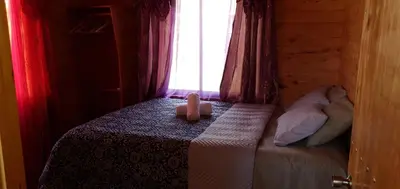 a bedroom with a bed with two teddy bears on it at Cabaña Tio King in Uvita
