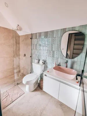 a bathroom with a toilet and a sink and a mirror at Little Escape in Santa Teresa Beach