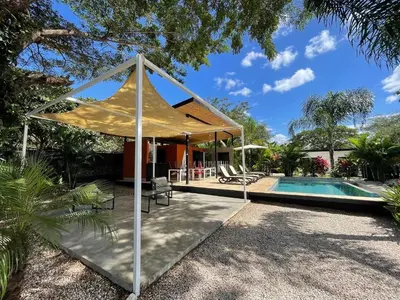 a house with a pool and a tent at Pyramid Tamarindo Luxury Hotel in Tamarindo