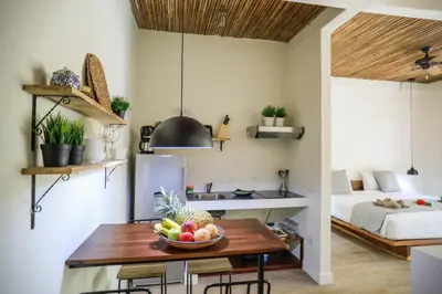 a kitchen with a table with a bowl of fruit on it at Manala Hotel in Santa Teresa Beach