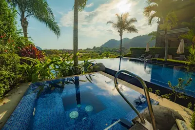 a swimming pool with a hot tub next to a resort at Vista Bahia 3D 3 bdr Ocean View in Los Suenos in Herradura