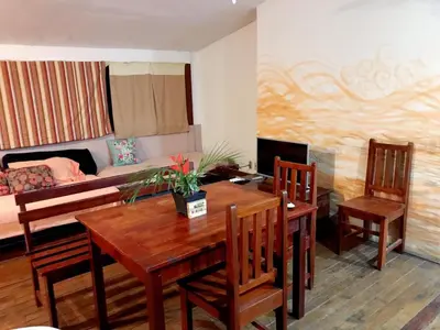 a living room with a table and chairs and a couch at Beautiful Second Story Apartment 202 Next to Playa Flamingo in Playa Flamingo
