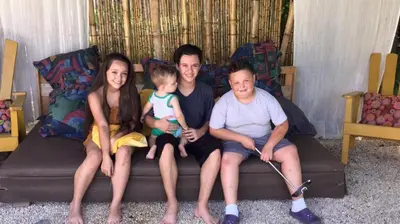 a group of people sitting on a couch at Beautiful Second Story Apartment 202 Next to Playa Flamingo in Playa Flamingo
