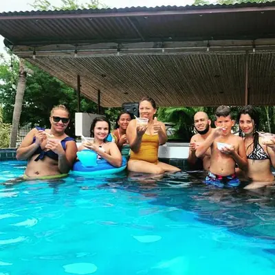 a group of people sitting in a swimming pool at Beautiful Second Story Apartment 202 Next to Playa Flamingo in Playa Flamingo