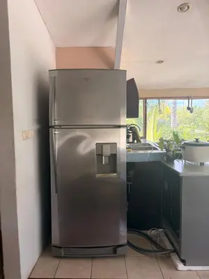 a stainless steel refrigerator in a kitchen next to a sink at Beautiful Second Story Apartment 202 Next to Playa Flamingo in Playa Flamingo