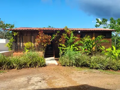 a small house with a dirt road in front of it at Jaco-Carara 3 bdrm surrounded by rainforest with private pool in Carara