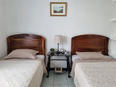 two beds sitting next to each other in a bedroom at Entire Cozy apartment for you, 5 min SJO Airport in Alajuela City