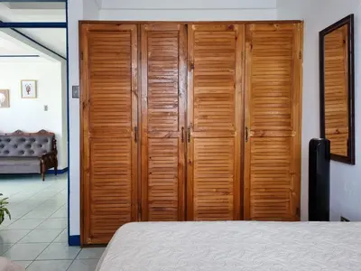 a bedroom with wooden cabinets and a bed at Entire Cozy apartment for you, 5 min SJO Airport in Alajuela City