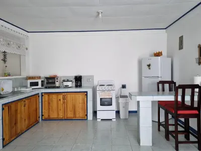 a kitchen with a stove and a refrigerator at Entire Cozy apartment for you, 5 min SJO Airport in Alajuela City