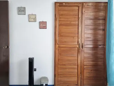 a wooden door in the corner of a room at Entire Cozy apartment for you, 5 min SJO Airport in Alajuela City
