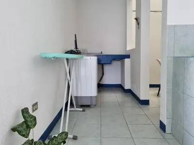a hallway with a blue sink in a room at Entire Cozy apartment for you, 5 min SJO Airport in Alajuela City