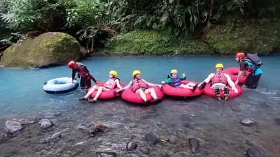 a group of people in inflatable rafts on a river at Hotel Rio Celeste to Know in Rio Celeste