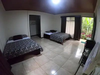 a hotel room with two beds and a window at Hotel Rio Celeste to Know in Rio Celeste