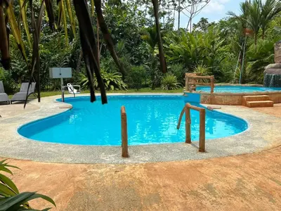 a large pool with blue water in a resort at Hotel Rio Celeste to Know in Rio Celeste