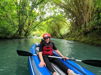 a young girl in a kayak on a river at Hotel Rio Celeste to Know in Rio Celeste