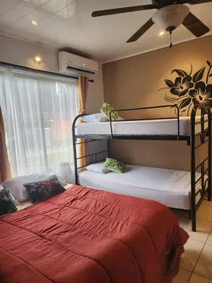 a bedroom with two bunk beds and a ceiling fan at Elegant Villa in La Fortuna with spacious backyard plus very private pool & parking in Fortuna