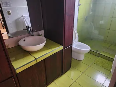 a bathroom with a bowl sink and a toilet at Elegant Villa in La Fortuna with spacious backyard plus very private pool & parking in Fortuna