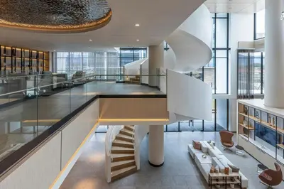 a large room with a staircase in a building at AC Hotel San Jose Airport Belen in San José