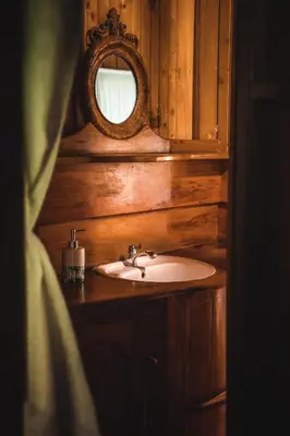 a bathroom with a sink and a mirror at Ocean Forest Ecolodge in San Pedrillo